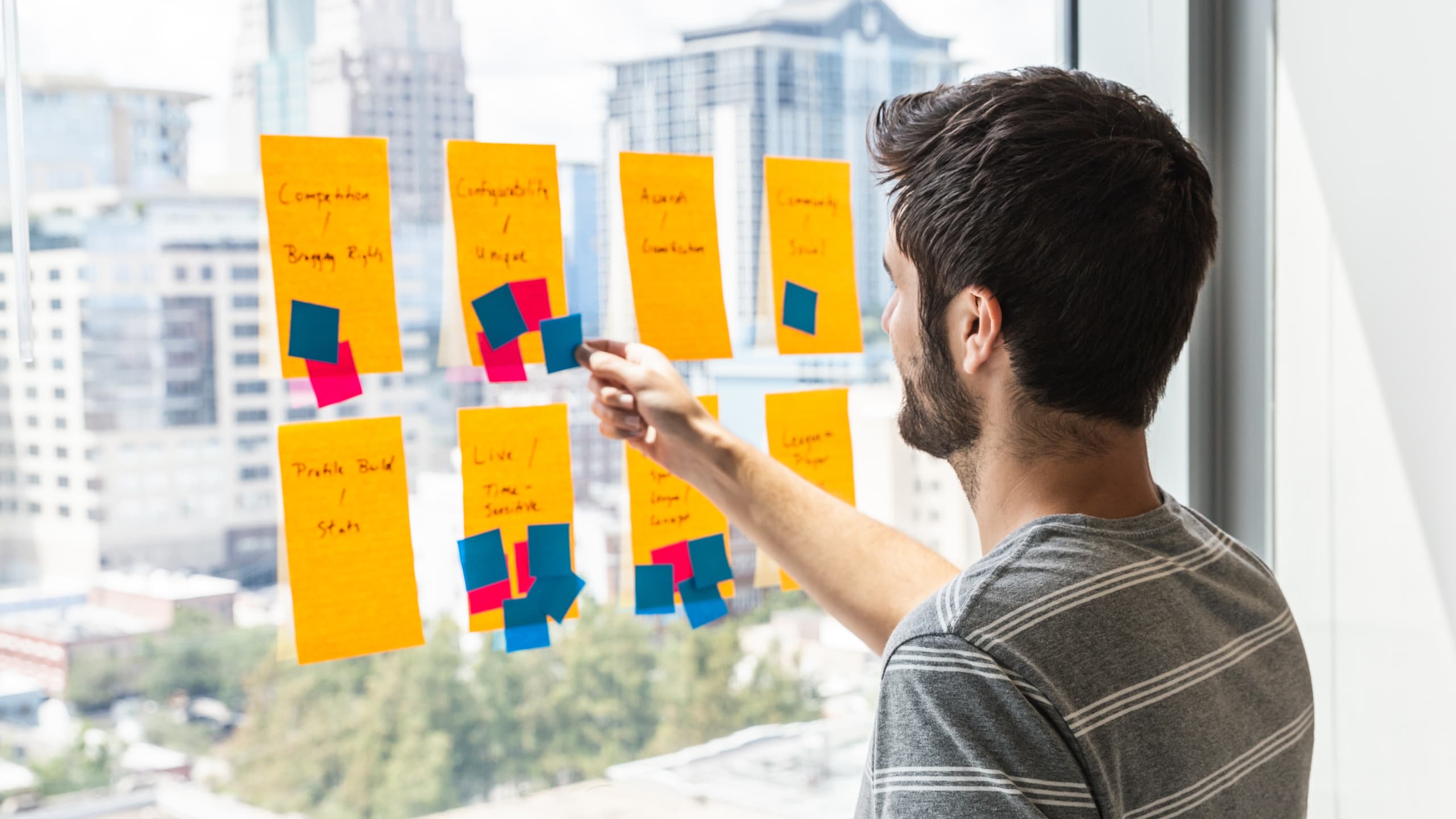 Nick Walsh casts his vote with a sticky note, leading a dot voting UX exercise